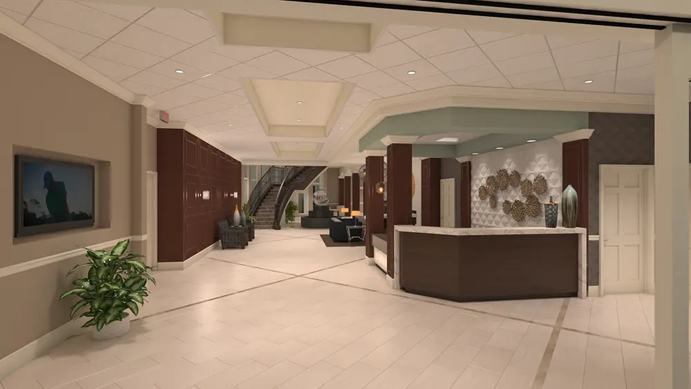 L1_0084 Modern hotel lobby with tiled floors, a reception desk, seating area, indoor plants, wall art, and a staircase leading to an upper level.
