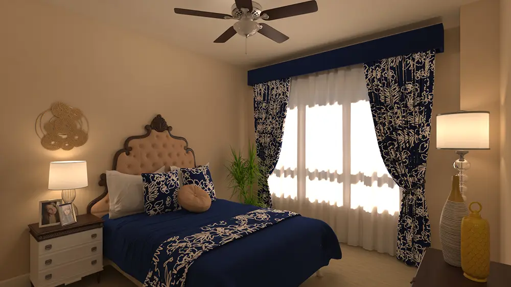RU-c3-2_0249 A bedroom with a bed featuring blue and white floral bedding, matching curtains, two lamps, a ceiling fan, and beige walls.